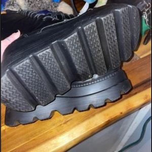 Black leather combat platform boots.